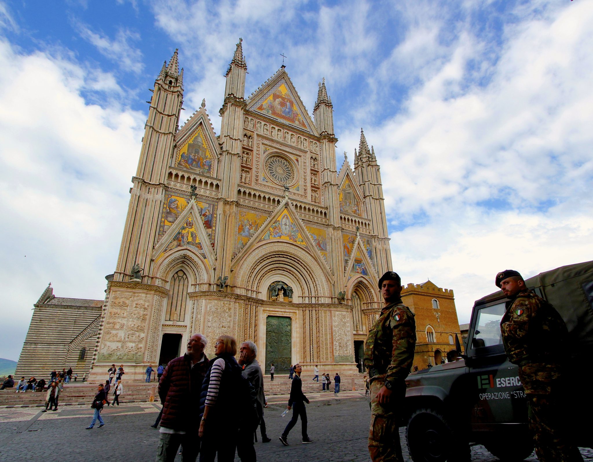 Italian soldiers guard the gold-gilded facade of Orvieto's cathedral